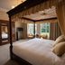 Tre-Ysgawen Hall & Spa in Llangefni: four-poster bed, wardrobe, and sitting area by the window
