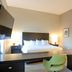 Hampton Inn Crystal River guest room with king bed, desk, TV, and adjoining bathroom