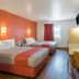Motel 6 Junction City, KS guest room with two beds, desk, TV and window