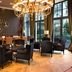 Hilton Frankfurt Gravenbruch lounge in Neu Isenburg with chandelier, armchairs, and floor-to-ceiling windows