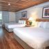Carter Caves State Resort room in Olive Hill with two beds, wood floors, and a balcony door