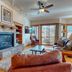 Eagleridge Lodge & Townhomes in Steamboat Springs living room with stone fireplace and mountain-view balcony