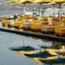 Myconian Korali Relais & Chateaux in Mykonos: poolside loungers with yellow umbrellas and sea views