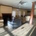 Truckerz Inn Jacksonville lobby lounge with chairs, ceiling fan, fireplace and sunlit windows