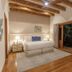 Visus Hotel Boutique & Spa in Fonda Central with a bedroom, exposed beams, and garden view through sliding doors