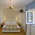 Hotel La Pace Viareggio room with twin bed, chandelier, bedside lamps and open window