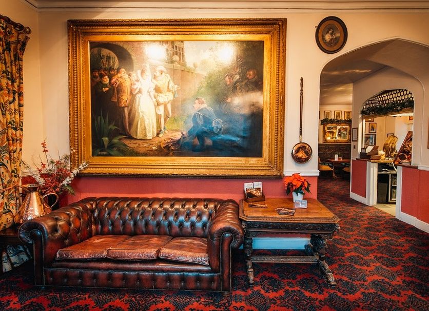 The Bedford Hotel Tavistock lobby with leather sofa, ornate painting and arched doorway