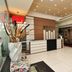 Hotel Vijay Parkinn, Coimbatore lobby with reception desk, tiled floor and decorative floral arrangement