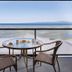 The Beach Club Resort in Parksville balcony with table and chairs overlooking the beach and ocean