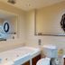 The Coal Exchange Hotel Cardiff bathroom with soaking tub, toilet and decorative round mirror
