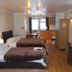 Novello Blackpool twin room with wood floors, flat-screen TV, and kitchenette in Blackpool