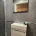 The Leather Bottle, Gravesend: compact bathroom with glass shower enclosure and wall-mounted sink