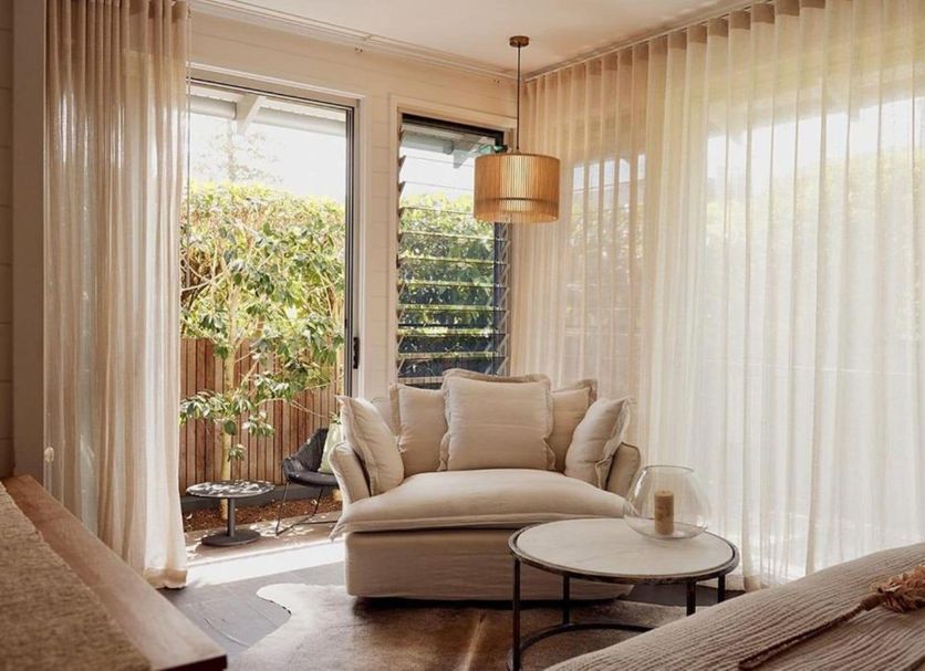 28 Degrees Byron Bay - Adults Only lounge with chaise, round table, and sliding doors to garden