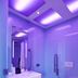 citizenM Rome Isola Tiberina bathroom with purple-lit ceiling, wall-mounted sink and toilet in Rome