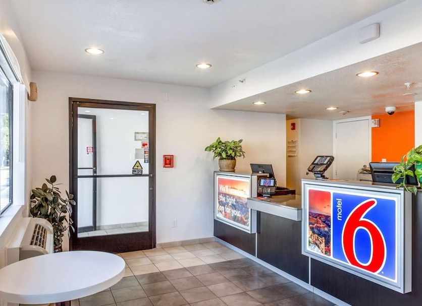 Motel 6-Phoenix, AZ - West lobby reception desk in Phoenix with seating and glass entry door