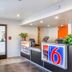 Motel 6-Phoenix, AZ - West lobby reception desk in Phoenix with seating and glass entry door