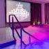 La Villa Haussmann Paris indoor pool with purple lighting and chandelier reflection