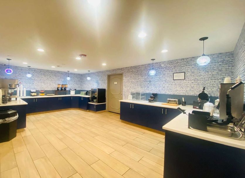 AmericInn by Wyndham Glendale/Milwaukee lobby breakfast area with self-serve counters and seating