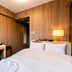 Koko Hotel Asahikawa Station room in Asahikawa with bed, desk, chair and bedside lamp