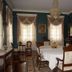 Dansereau House in Thibodaux elegant dining room with chandelier, antique chairs and table