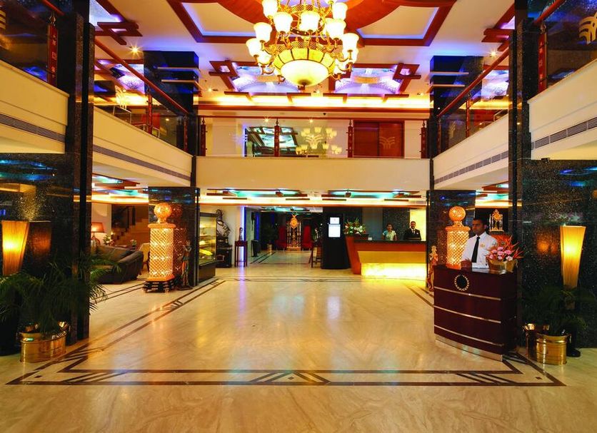 Windsor Rajadhani Hotel lobby in Thiruvananthapuram with chandelier and marble floor