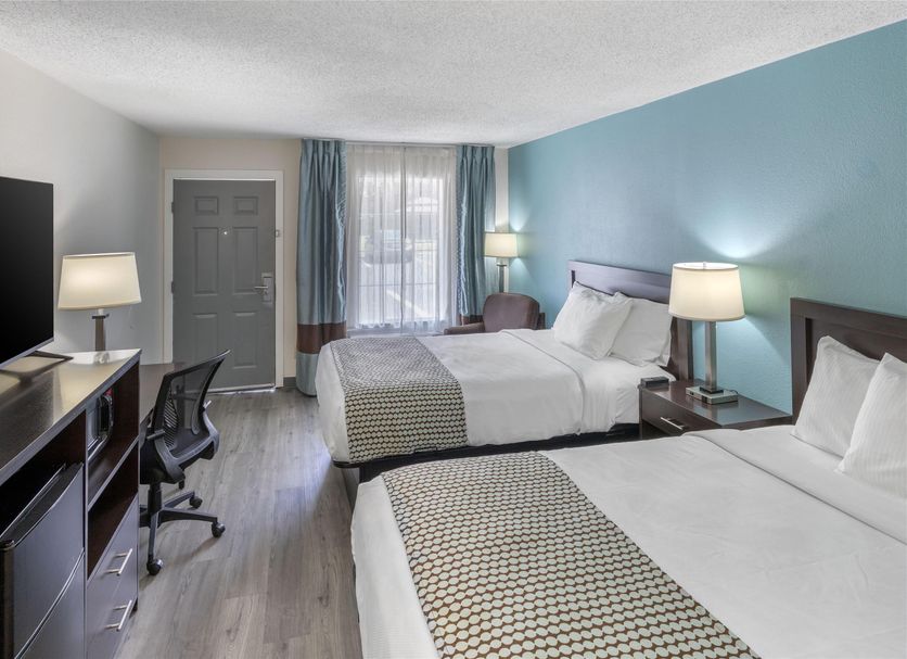 SureStay Plus by Best Western Asheboro guest room with two beds, desk, TV and blue accent wall