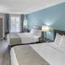 SureStay Plus by Best Western Asheboro guest room with two beds, desk, TV and blue accent wall