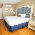 84 Main in Kennebunk bedroom with king bed, patterned headboard, TV, dresser and hardwood floors