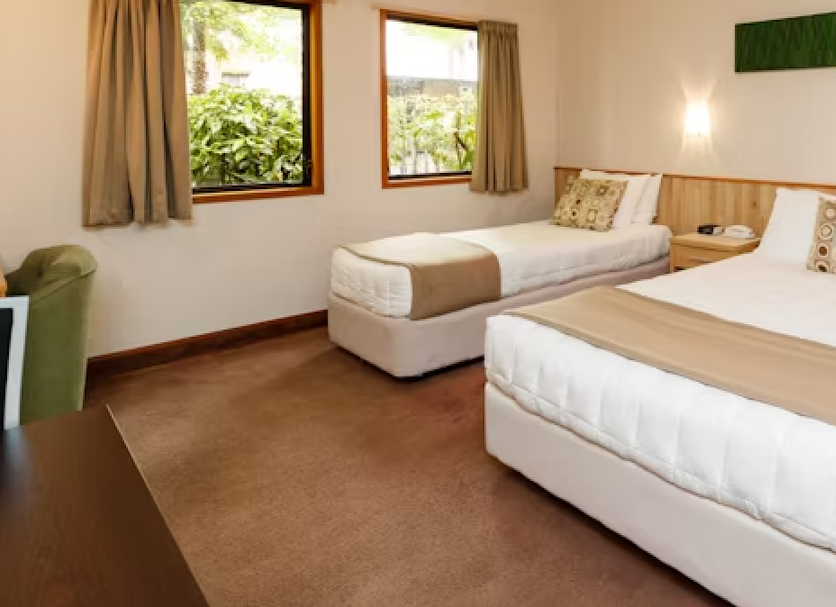 Fitzherbert Castle Motel, Palmerston North guest room with two beds, windows and bedside table
