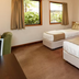 Fitzherbert Castle Motel, Palmerston North guest room with two beds, windows and bedside table