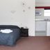 Midtown Motor Inn Whanganui room with queen bed, bedside table and kitchenette
