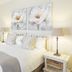 Kingfisher Guesthouse in Port Elizabeth bedroom with king bed, twin bedside lamps, and floral wall art