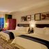 The Reserve at Park MGM Las Vegas guest room with two beds, lounge seating, and city view
