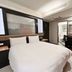 Guide Hotel Taipei Xinyi guest room with double bed, desk, chair and vanity mirror in Taipei City