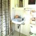 Mountain Harbor Resort and Spa Mount Ida bathroom with pedestal sink, mirror, shower curtain, and wall decor