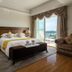 Forum For Asia Gold Coast Hotel Qionghai room with balcony and ocean view, king bed and sofa