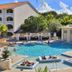 Presidential Suites by Lifestyle, Puerto Plata: outdoor pool with loungers and cabanas beside resort buildings