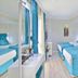 Glamour Hotel Istanbul Sirkeci room with two blue twin beds and window seating in Istanbul