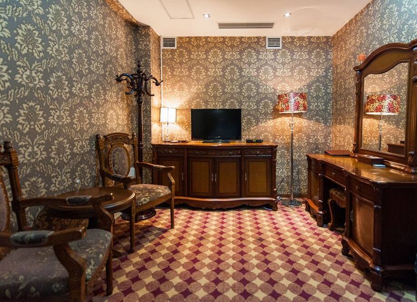 UB City Hotel, Ulaanbaatar lounge with patterned carpet, antique chairs, TV and vanity table