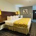 Baymont by Wyndham Chicago/Calumet City guest room with king bed and patterned carpet in Calumet City