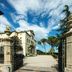 Hotel Villa Soligo entrance in Farra di Soligo with gated driveway, courtyard and blue sky