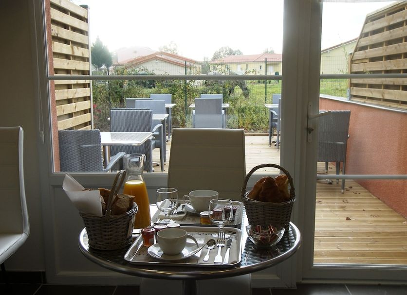 Hostellerie Del Matin Calme in Montverdun: breakfast table by glass door to patio seating