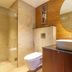 The Platinum Hotel Hyderabad bathroom with walk-in shower, toilet and vessel sink