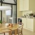Aperon Apartment Hotel in Copenhagen apartment kitchen with dining table and bedroom doorway