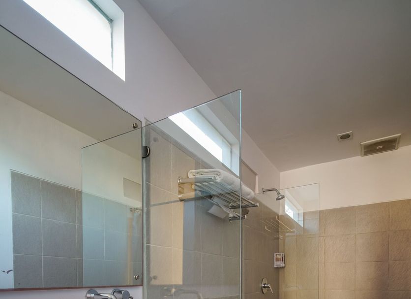 Ocean View Residence Jepara bathroom with glass shower, vessel sink, and toilet