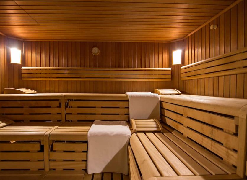 Hotel Wirthshof in Markdorf: wooden sauna with benches, towels, and warm ambient lighting