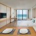 Tms Hotel Da Nang Beach suite with sea view, floor-to-ceiling windows, and kitchenette in Da Nang