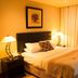 Zawadi House Arusha guest room with double bed, bedside lamps and floor-to-ceiling curtains