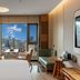 Puruihotel Yongkang in Jinhua guest room with city view through large window and seating area