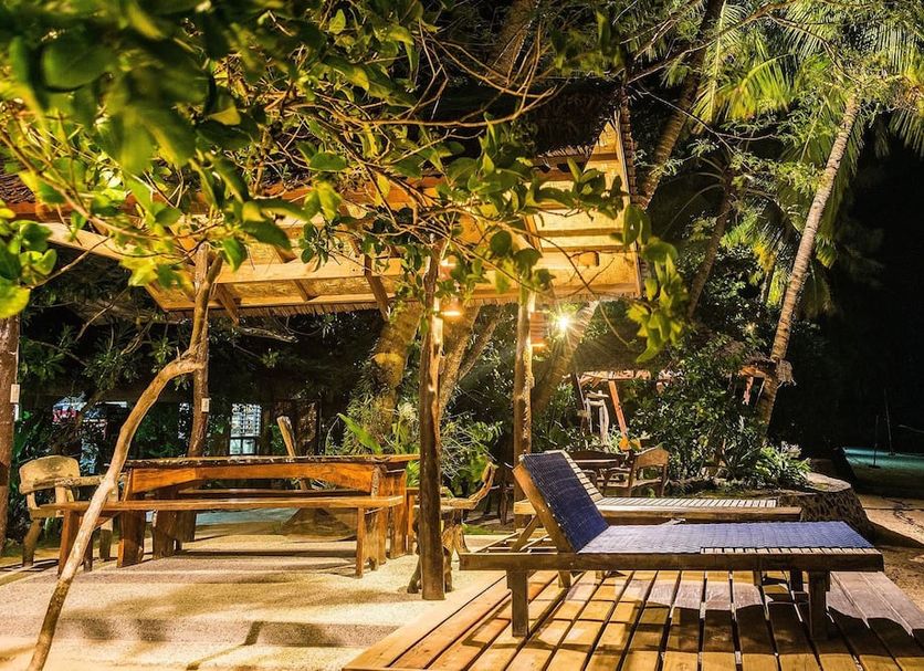 Patrick's on the Beach Resort, General Luna: beachfront cabana with lounge chairs under tropical palms